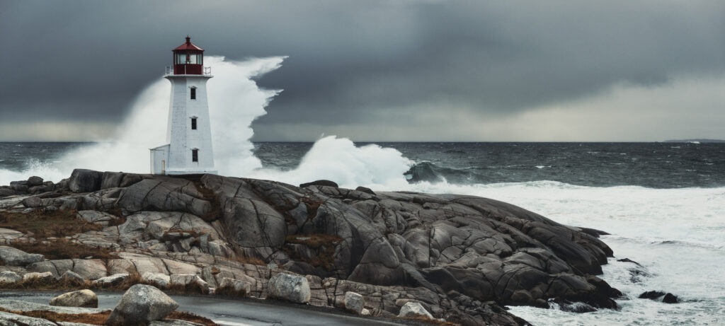 Waves crashing near a lighthouse.
